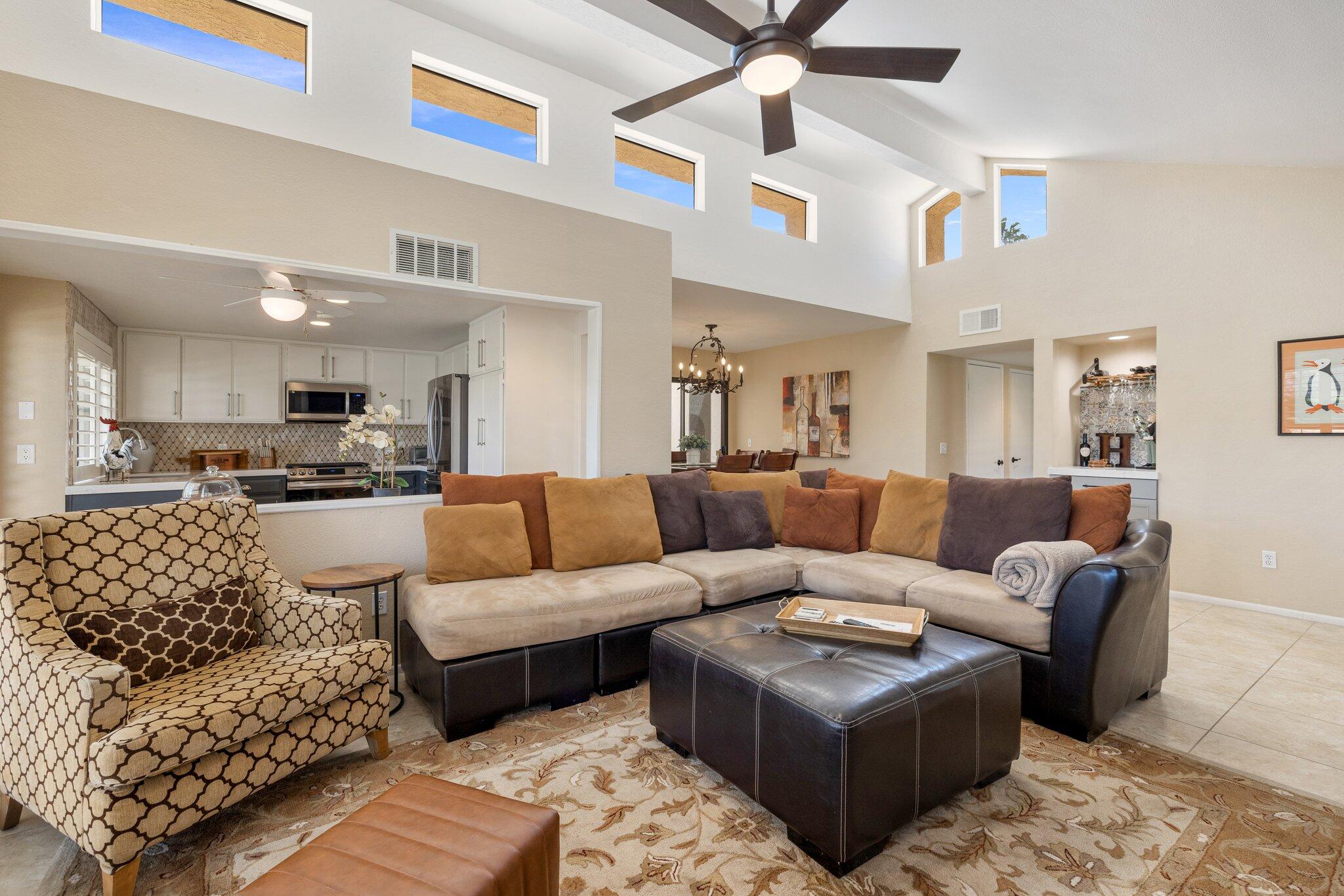 73750 Calle Bisque Palm Desert, CA 92260 - Photo 7 of 40 a living room with furniture kitchen view and a chandelier