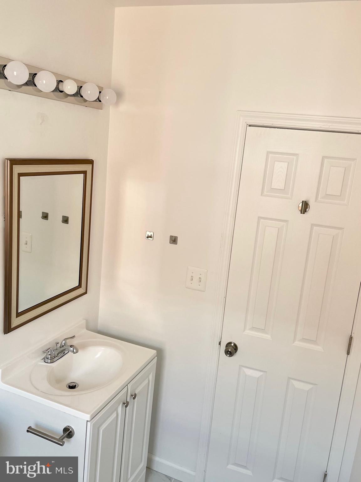 1838 C Street Southeast, Unit 1 Washington, DC 20003 - Photo 5 of 6 a bathroom with a sink and a mirror