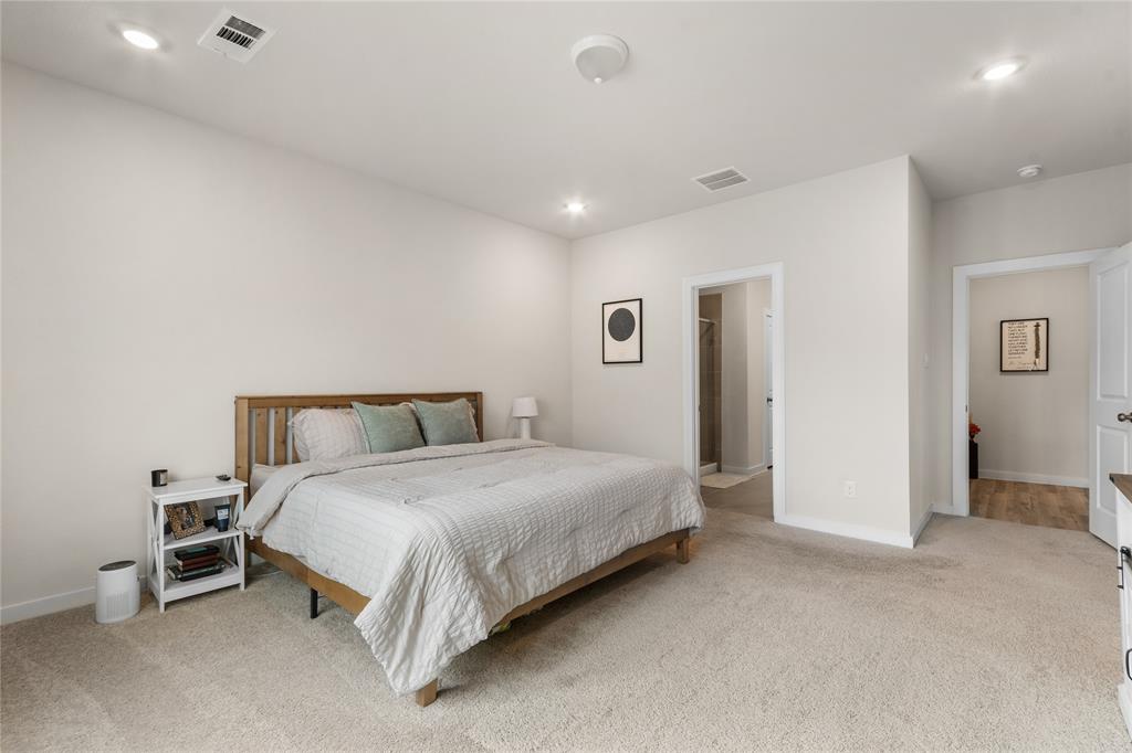 797 Vineyard Way Forney, TX 75126 - Photo 11 of 24 a spacious bedroom with a bed and a cabinets