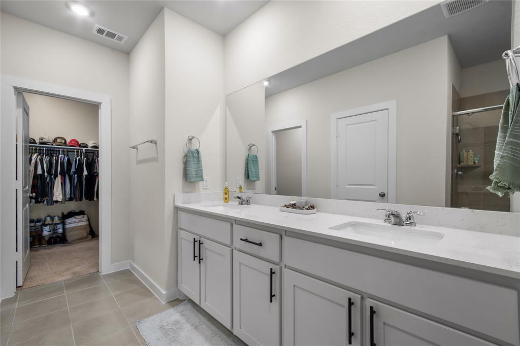 797 Vineyard Way Forney, TX 75126 - Photo 12 of 24 a spacious bathroom with a double vanity sink and a mirror