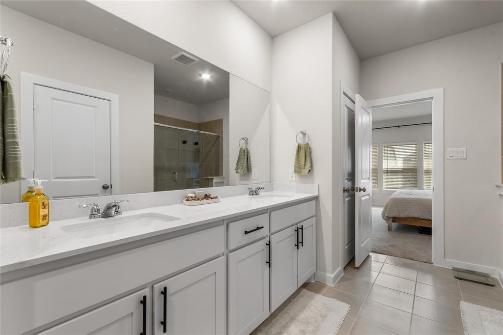 797 Vineyard Way Forney, TX 75126 - Photo 13 of 24 a en suite bathroom with double sink and a large mirror