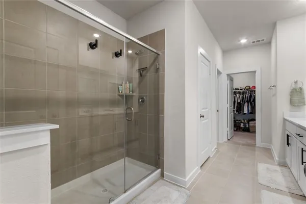 a bathroom with a shower and a sink
