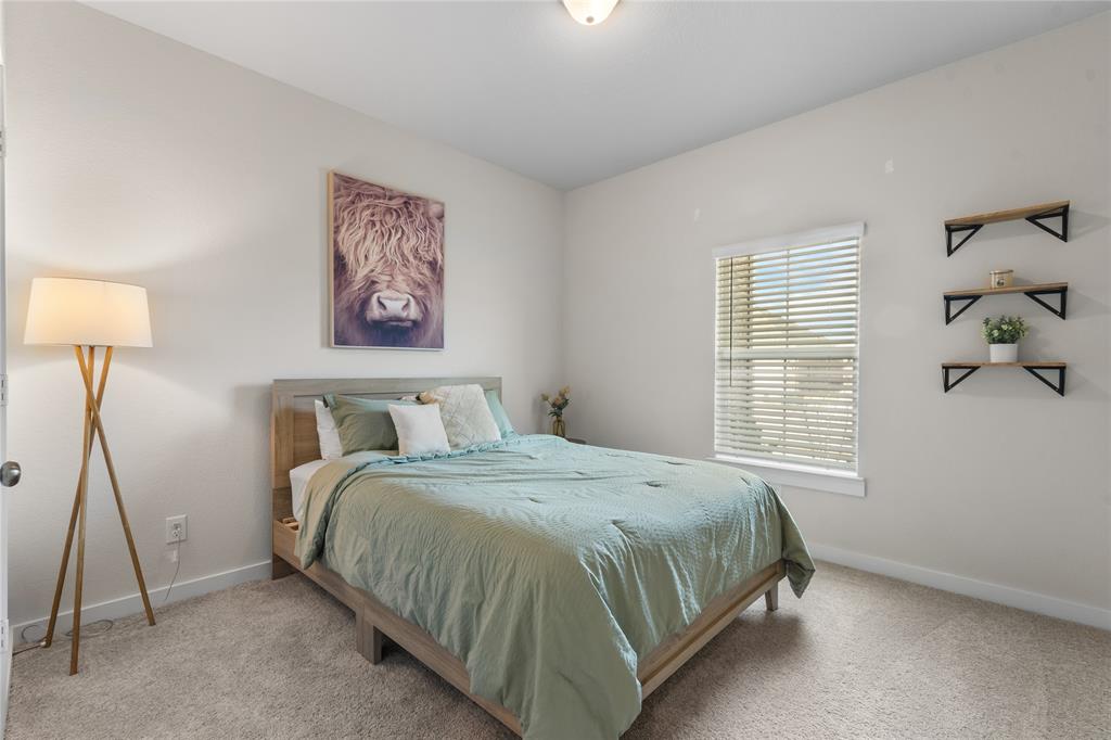 797 Vineyard Way Forney, TX 75126 - Photo 17 of 24 a bedroom with a bed and a window