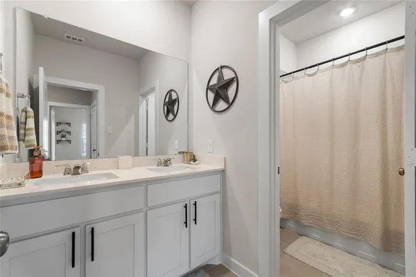 a bathroom with a double vanity sink and a mirror