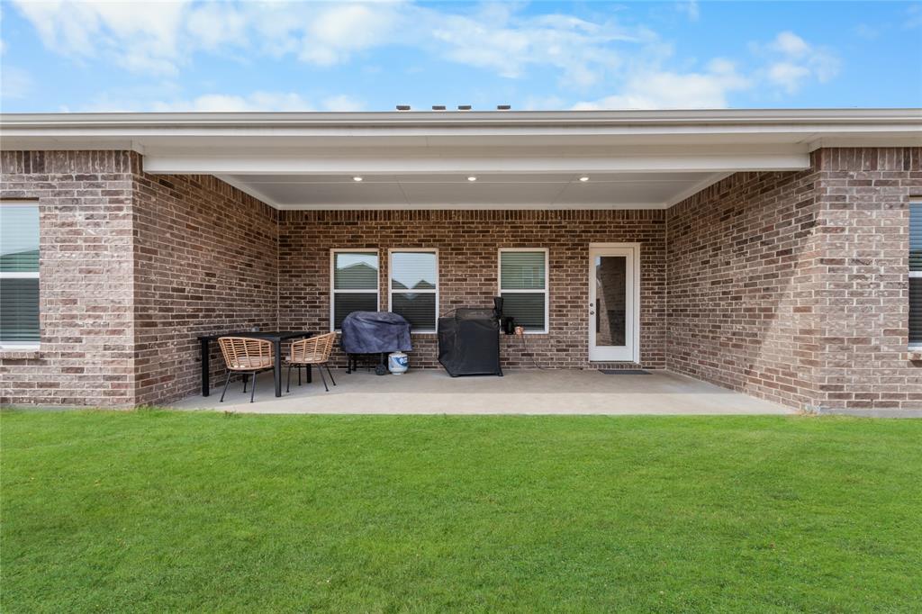 797 Vineyard Way Forney, TX 75126 - Photo 23 of 24 a backyard of a house with table and chairs
