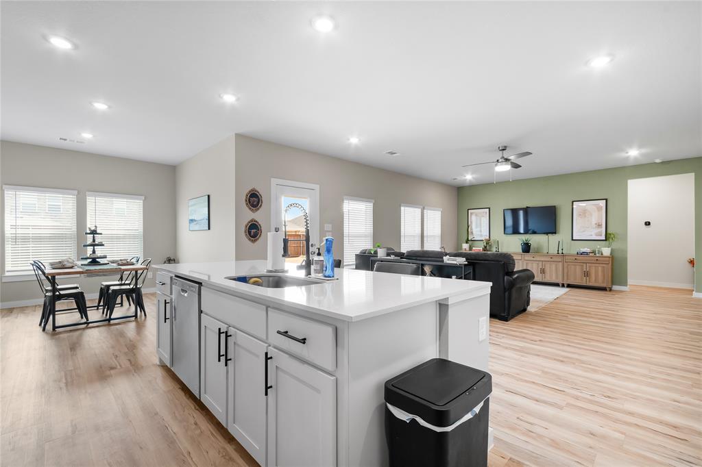 797 Vineyard Way Forney, TX 75126 - Photo 6 of 24 a kitchen with sink stove and wooden floor