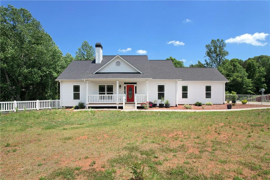 5875 Henson Road Gainesville, GA 30506 - Photo 1 of 1 a front view of a house with a garden and porch