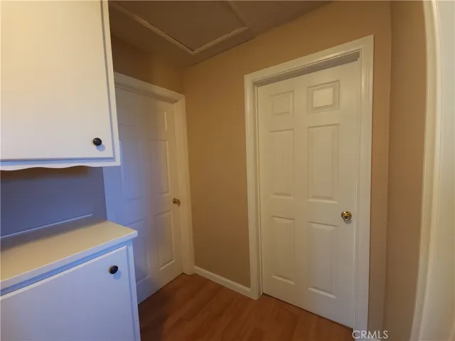 a view of wooden floor and windows in a room