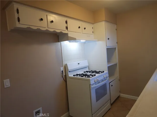 a room with white cabinets and a sink