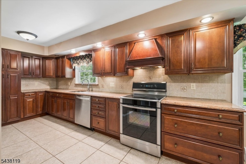 335 Drakestown Road Long Valley, NJ 07853 - Photo 8 of 34 a kitchen with stainless steel appliances granite countertop wooden cabinets a stove top oven a sink and dishwasher