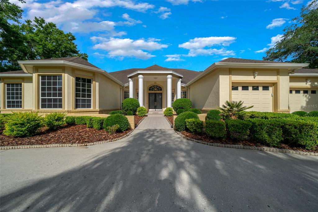 2272 Laurel Run Drive Ocala, FL 34471 - Photo 1 of 1 a front view of a house with a garden