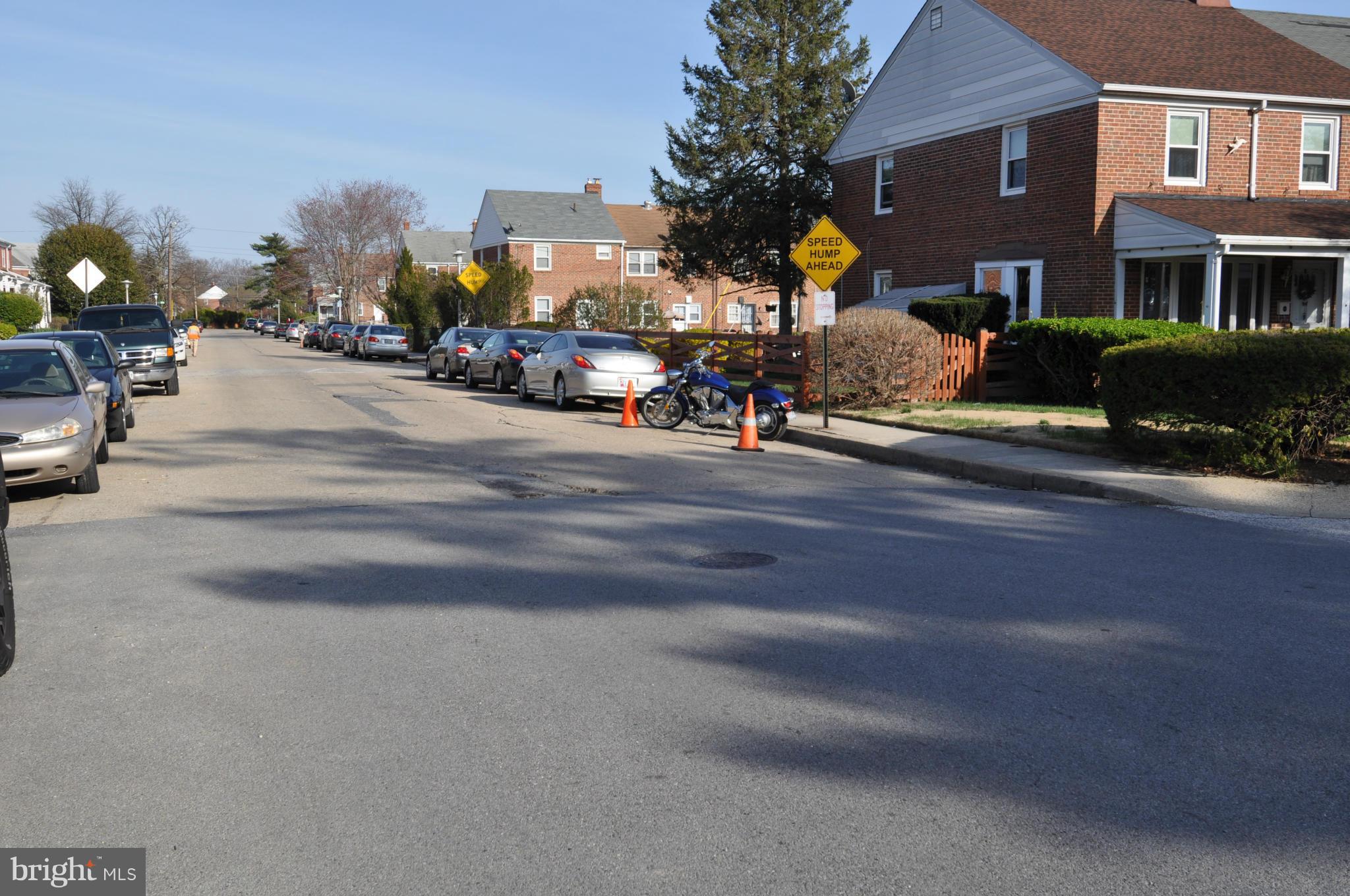 1126 Cedarcroft Road Baltimore, MD 21239 - Photo 22 of 23 a man walking down a street next to a building
