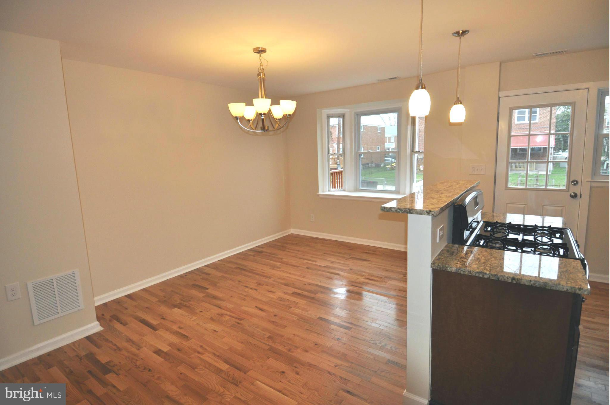 1126 Cedarcroft Road Baltimore, MD 21239 - Photo 8 of 23 a view of livingroom and kitchen with wooden floor
