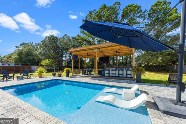 a view of a patio with a table and chairs
