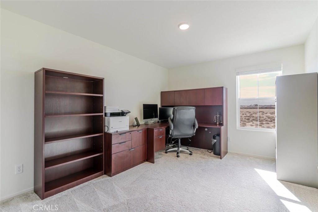2133 East Kettering Street Lancaster, CA 93535 - Photo 18 of 32 a living room with a chair and a lamp