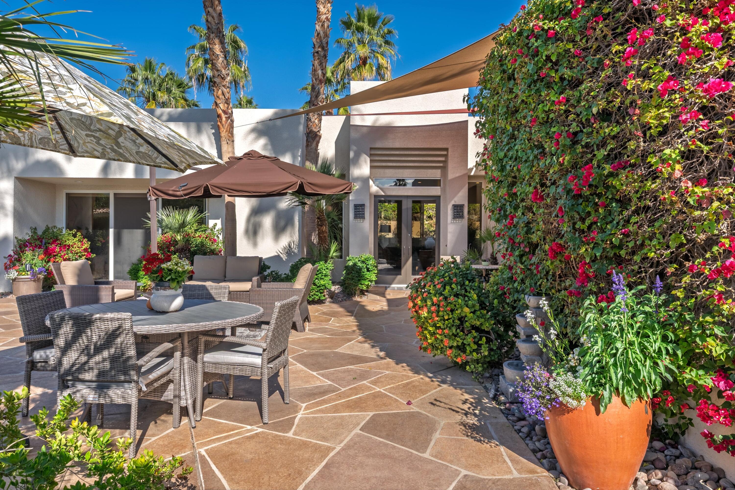 79160 Jack Rabbit Trail La Quinta, CA 92253 - Photo 3 of 30 a view of a patio with table and chairs under an umbrella