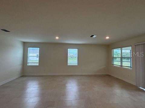 3974 Kennebunk Loop Mount Dora, FL 32757 - Photo 5 of 14 an empty room with wooden floor and windows