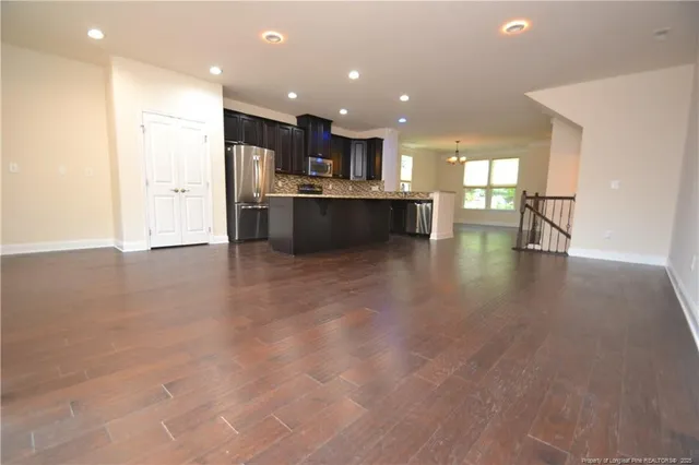 a view of kitchen with kitchen island and stainless steel appliances
