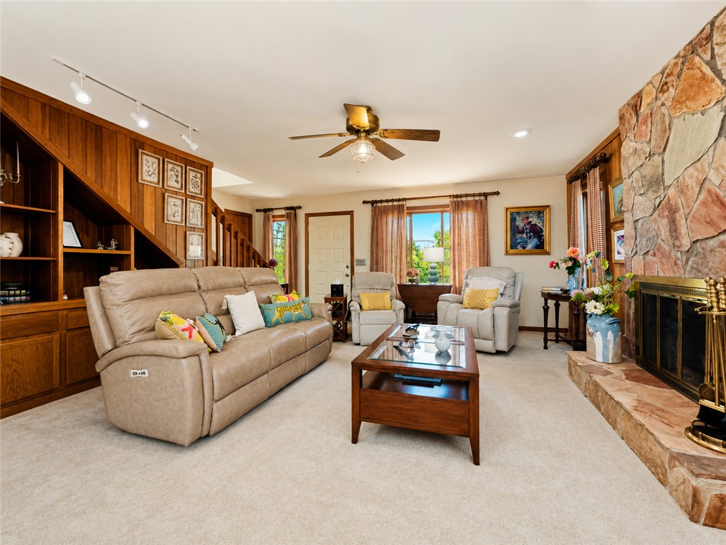 222 Terrace Drive Anderson, SC 29621 - Photo 10 of 37 Warm wood accents complement a stately stone fireplace, anchoring this comfortable living space.