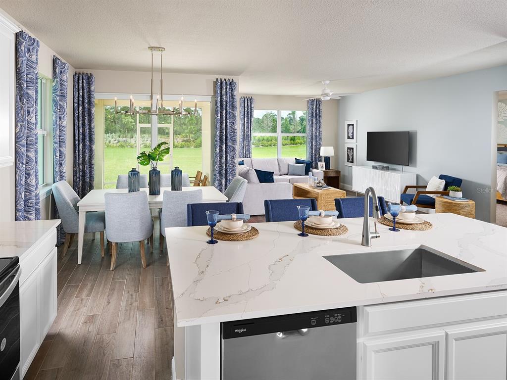 392 Birkdale Drive Daytona Beach, FL 32124 - Photo 2 of 6 a kitchen with a table chairs and flat screen tv