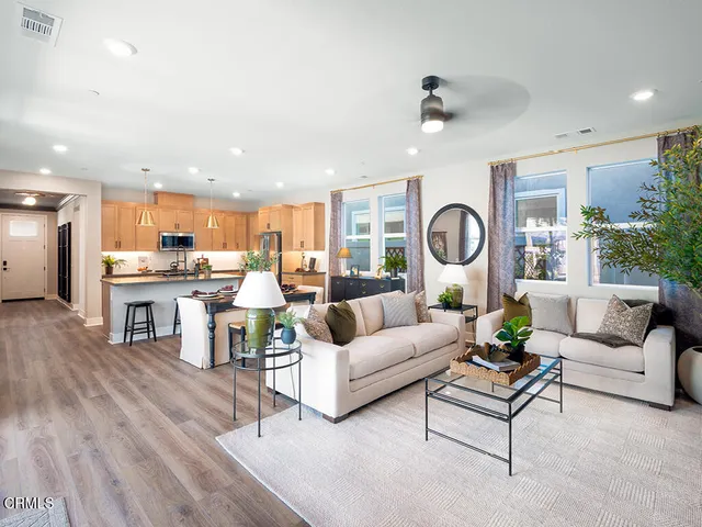 a living room with furniture and kitchen view