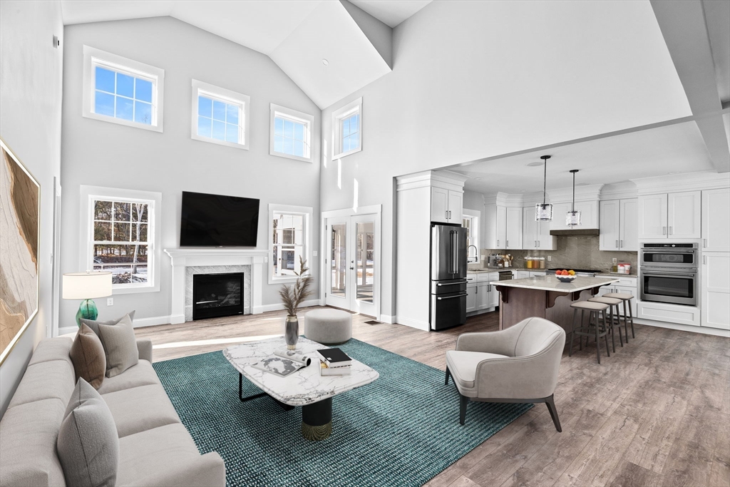6 Beacon Street, Unit 79 Onset, MA 02558 - Photo 3 of 13 a living room with furniture and a fireplace