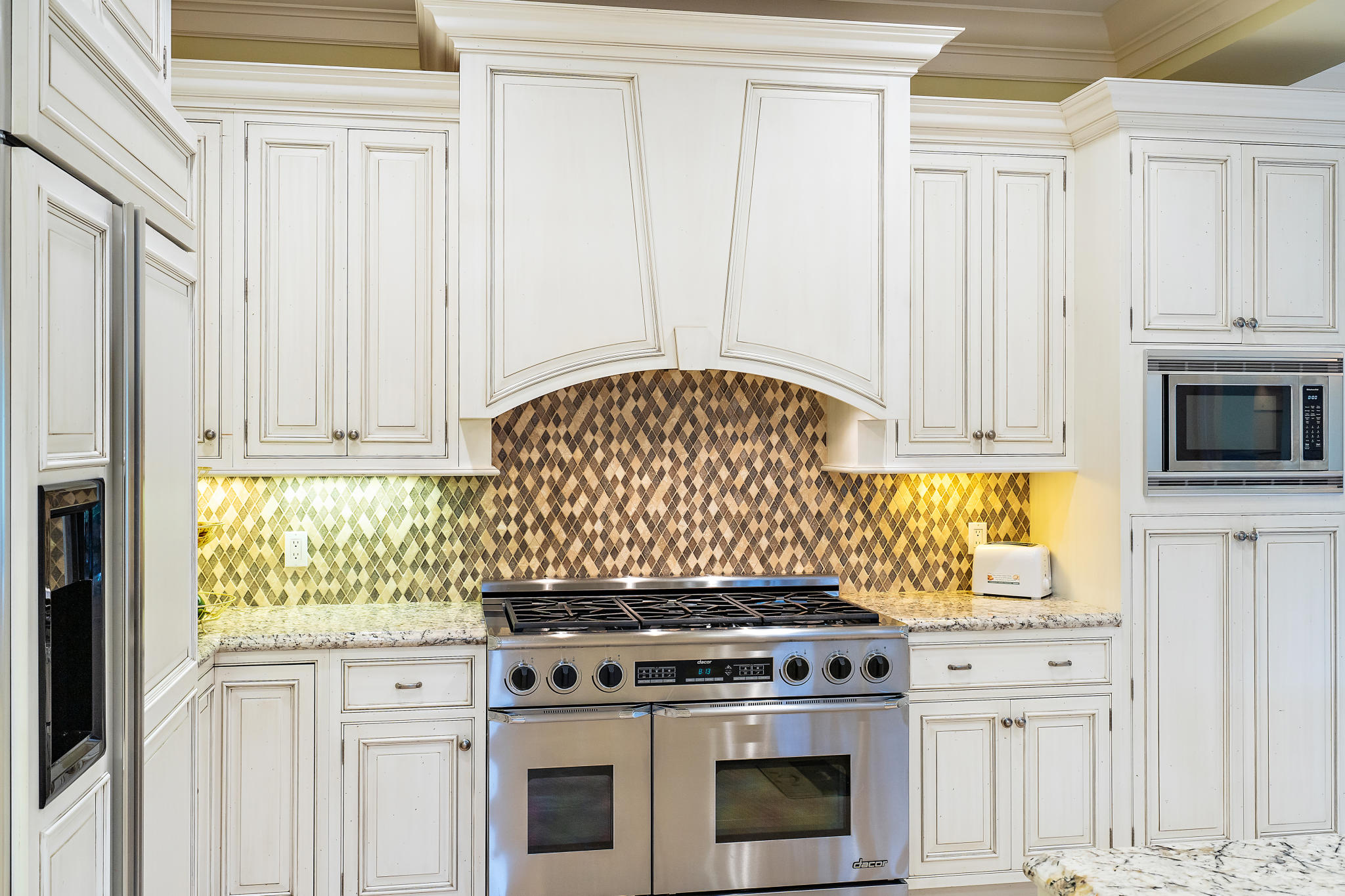 426 Red Hawk Drive Jupiter, FL 33477 - Photo 7 of 40 a kitchen with granite countertop white cabinets and appliances