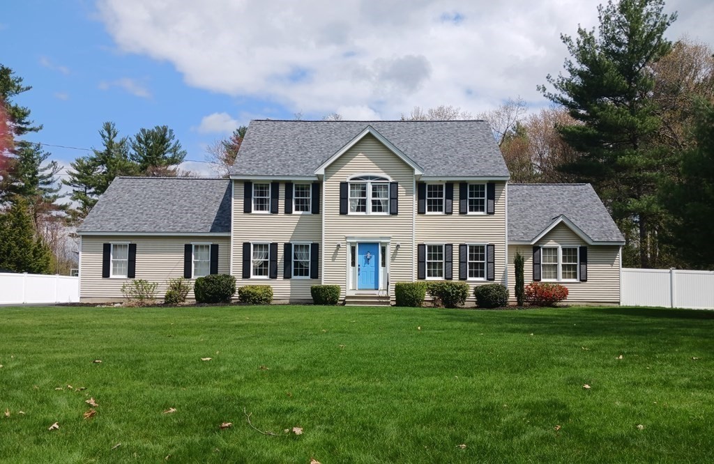 6 Winn Road Nashua, NH 03062 - Photo 1 of 33 a front view of a house with a garden and trees