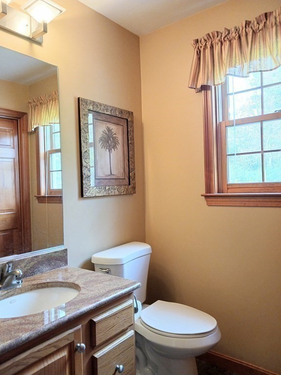 6 Winn Road Nashua, NH 03062 - Photo 14 of 33 a bathroom with a granite countertop toilet sink and mirror
