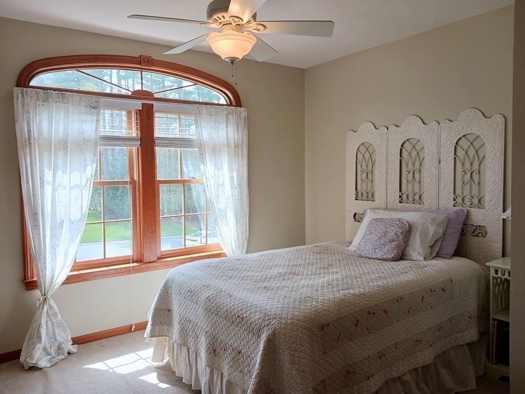 6 Winn Road Nashua, NH 03062 - Photo 25 of 33 a bedroom with a large bed and a large window