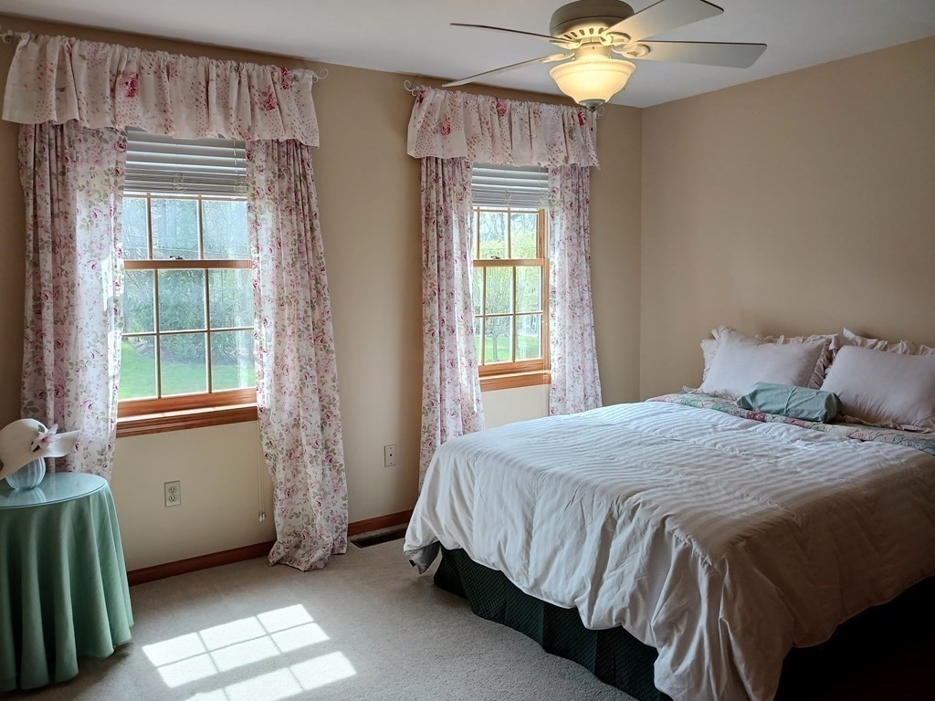 6 Winn Road Nashua, NH 03062 - Photo 27 of 33 a bedroom with a bed and a chandelier