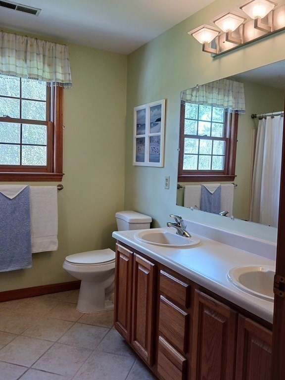 6 Winn Road Nashua, NH 03062 - Photo 29 of 33 a bathroom with a sink a toilet and a mirror