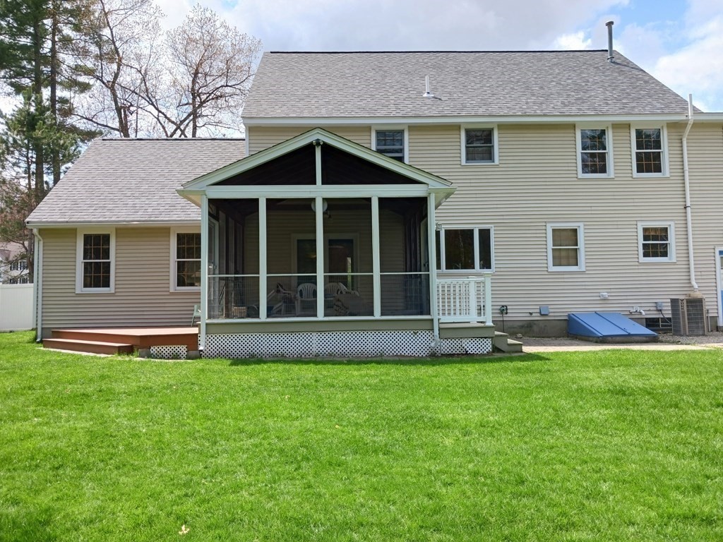 6 Winn Road Nashua, NH 03062 - Photo 3 of 33 a front view of a house with a yard and garage