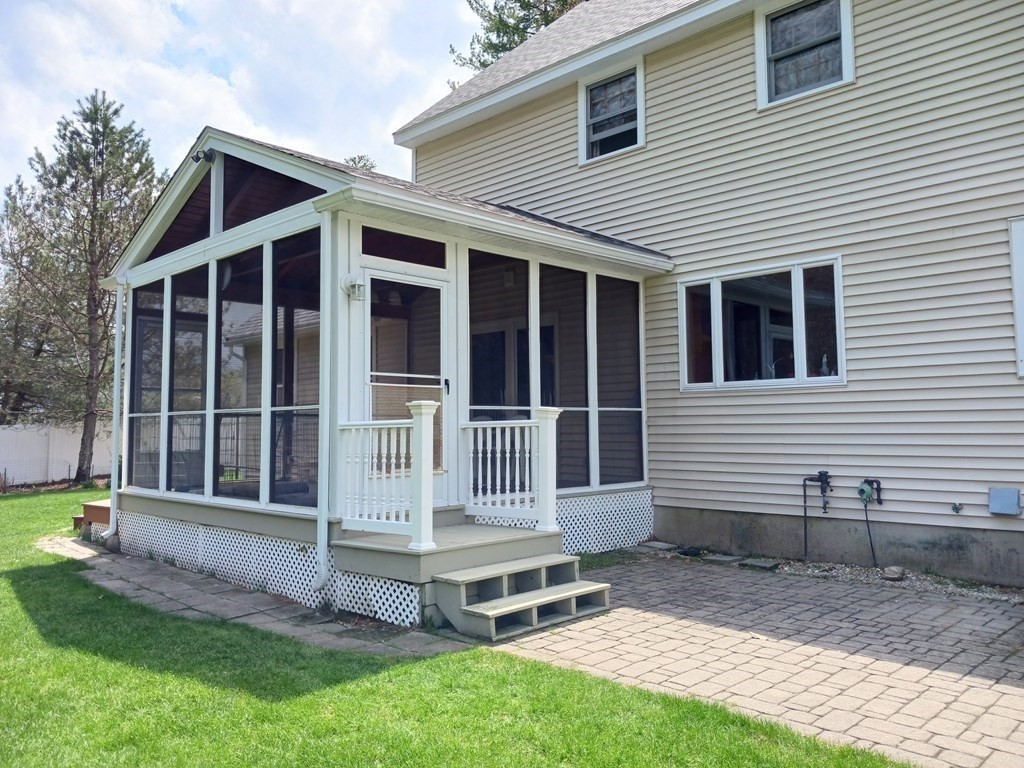 6 Winn Road Nashua, NH 03062 - Photo 4 of 33 a view of a house with a yard and wooden fence