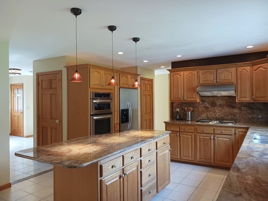 6 Winn Road Nashua, NH 03062 - Photo 9 of 33 a kitchen with stainless steel appliances granite countertop a sink a stove and a refrigerator