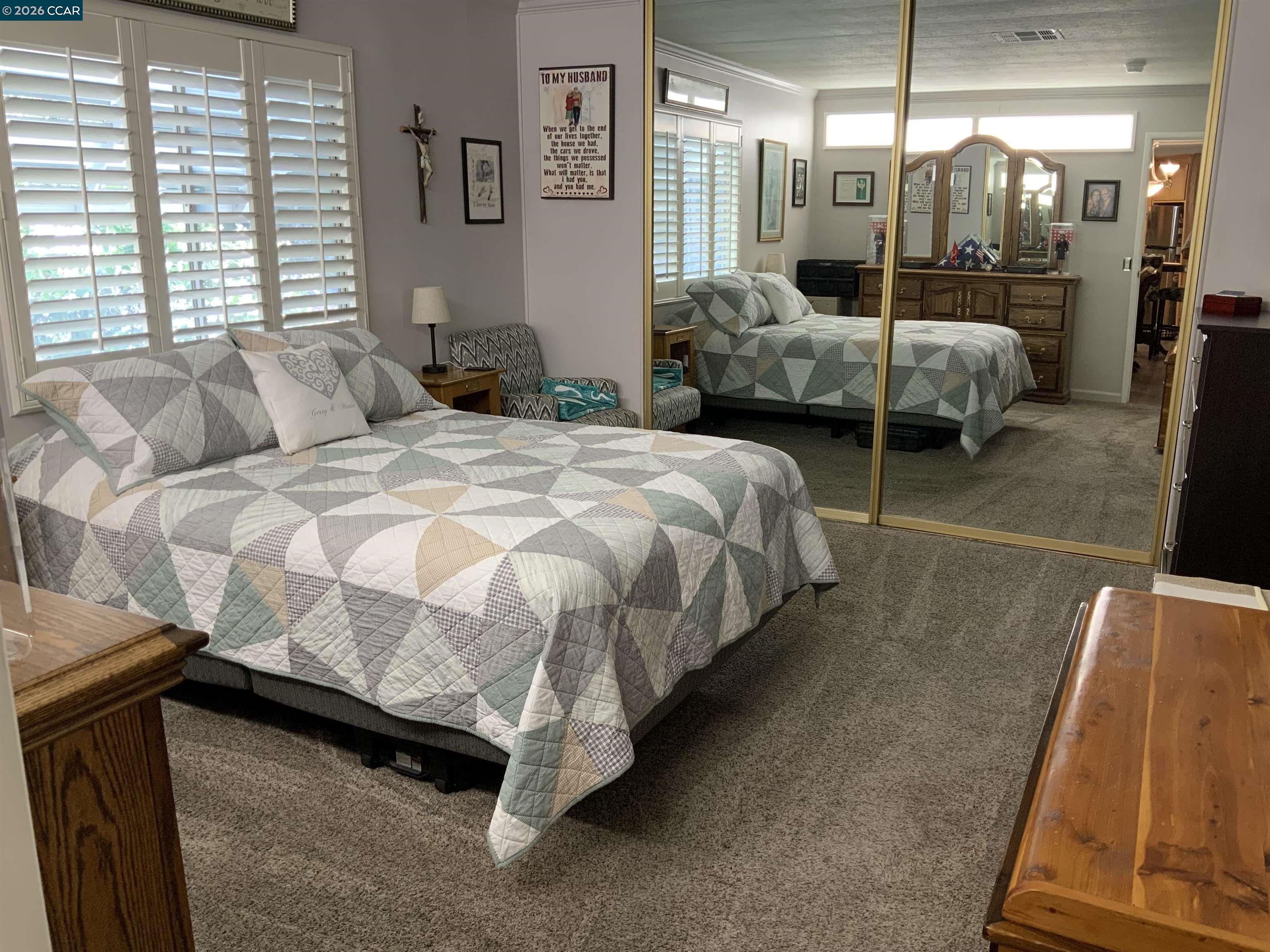 238 Aloha Pittsburg, CA 94565 - Photo 14 of 42 a bedroom with a bed and large mirror
