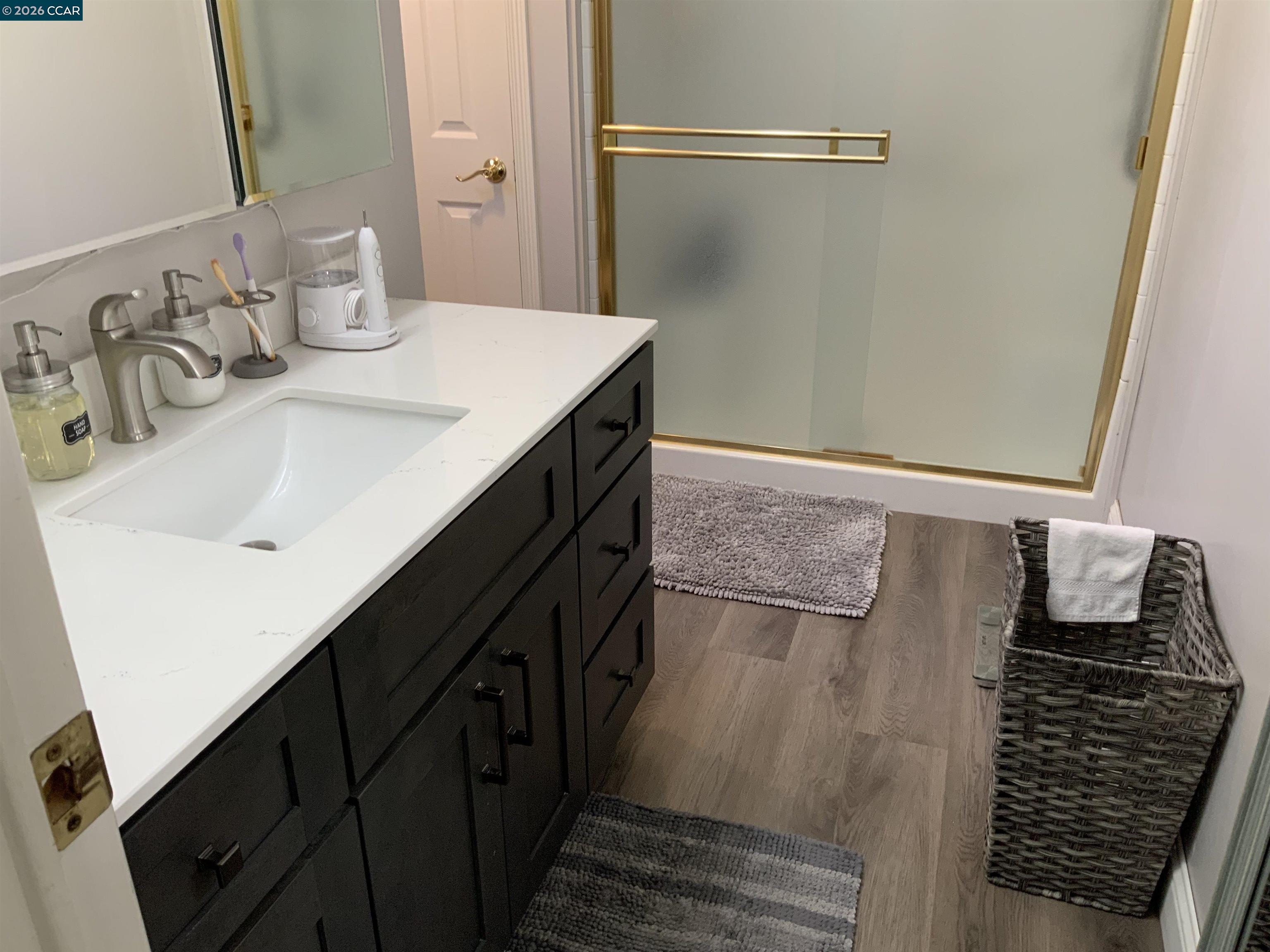 238 Aloha Pittsburg, CA 94565 - Photo 16 of 42 a bathroom with a double vanity sink and a mirror