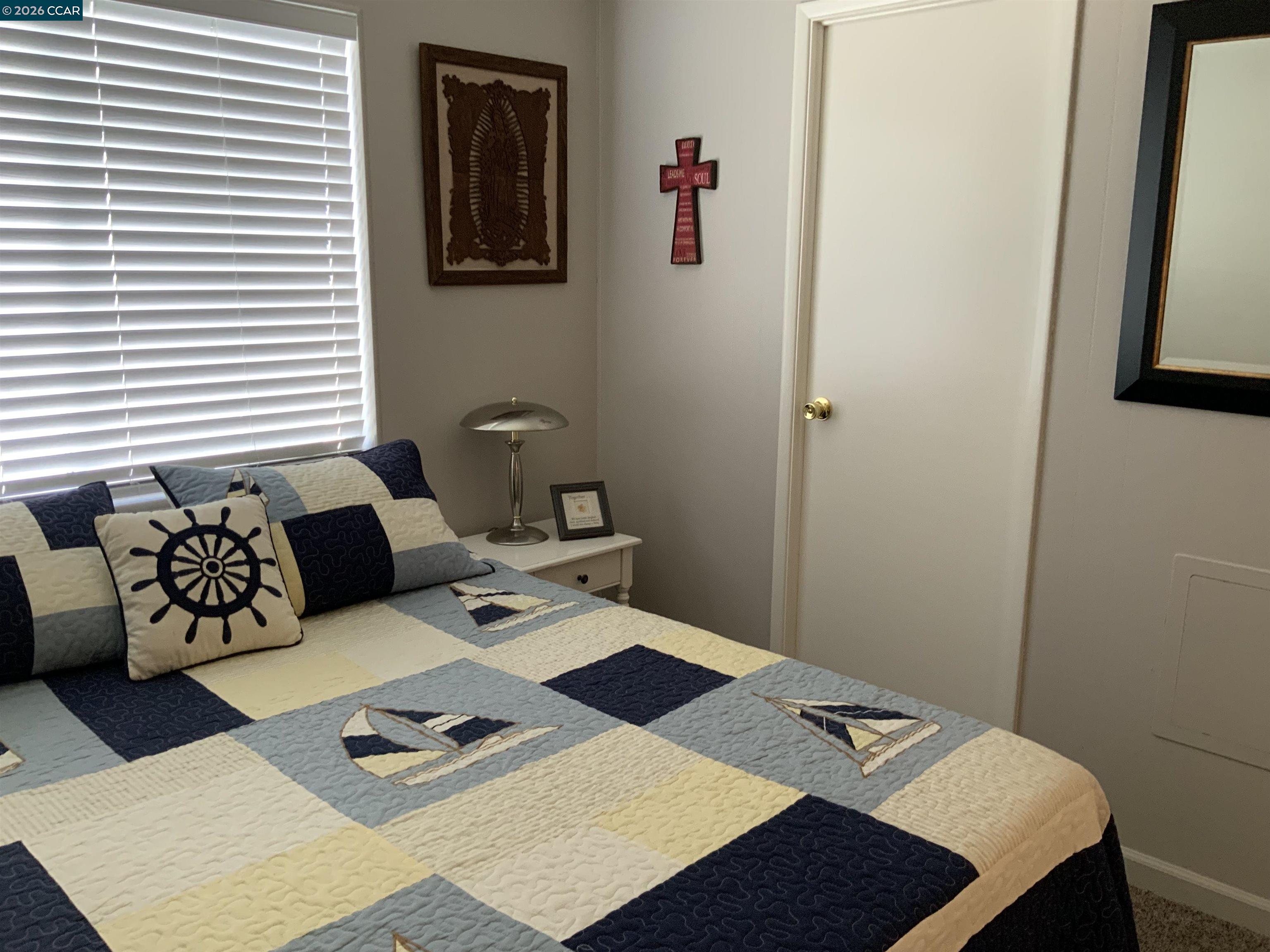 238 Aloha Pittsburg, CA 94565 - Photo 22 of 42 a bed room with a bed and a table