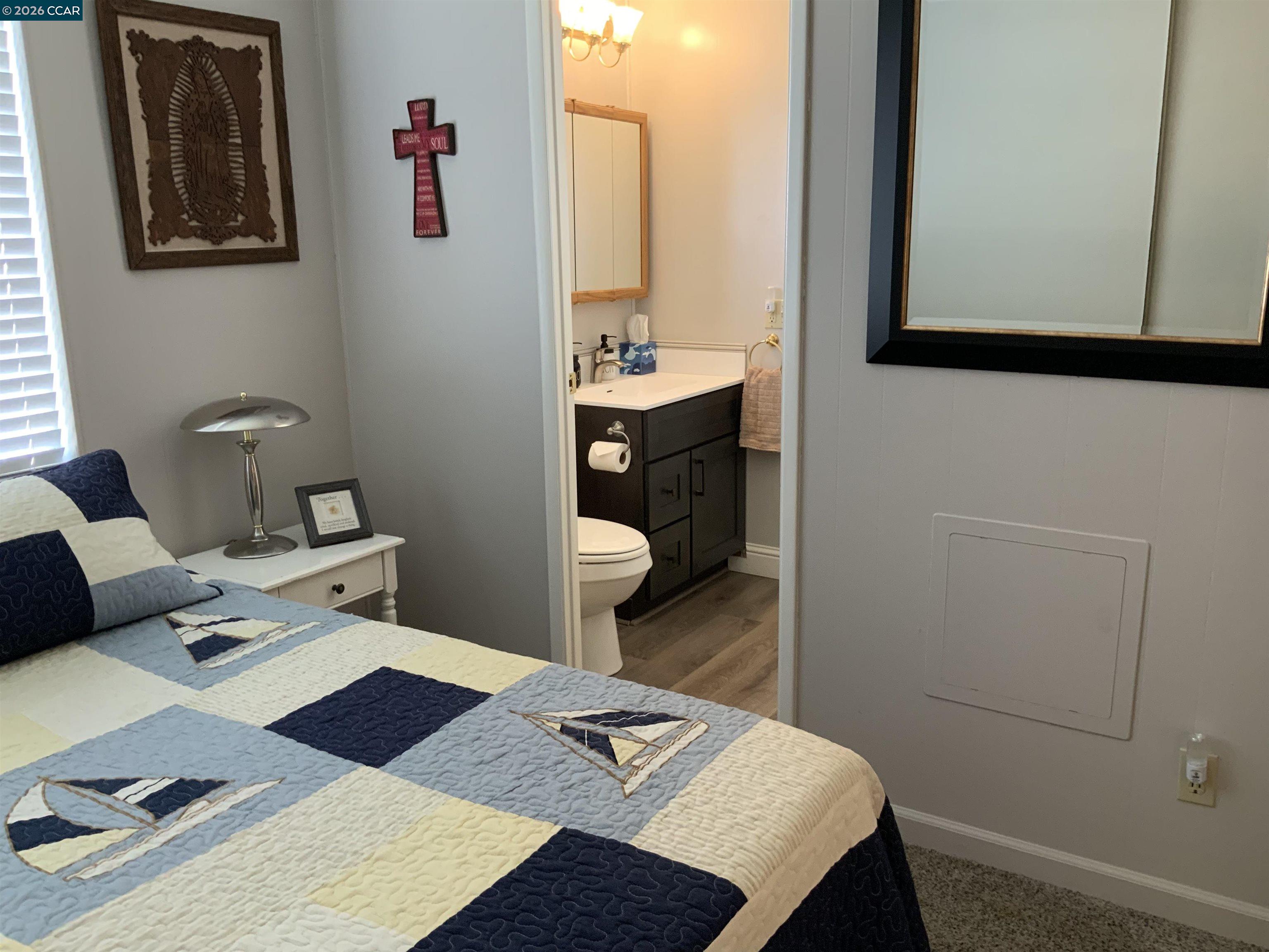 238 Aloha Pittsburg, CA 94565 - Photo 23 of 42 a bed room with a bed and a mirror