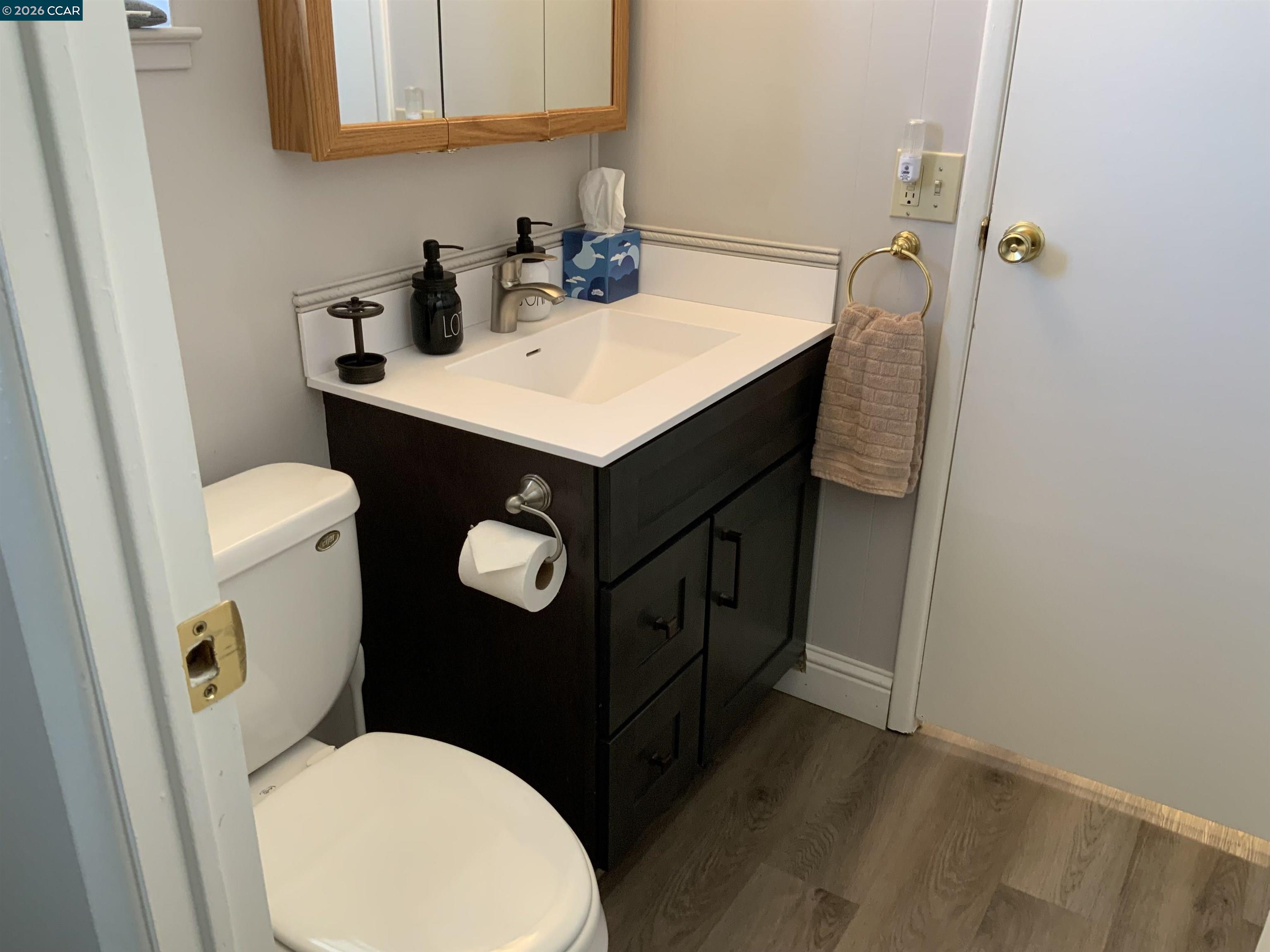 238 Aloha Pittsburg, CA 94565 - Photo 24 of 42 a bathroom with a sink a toilet and a mirror