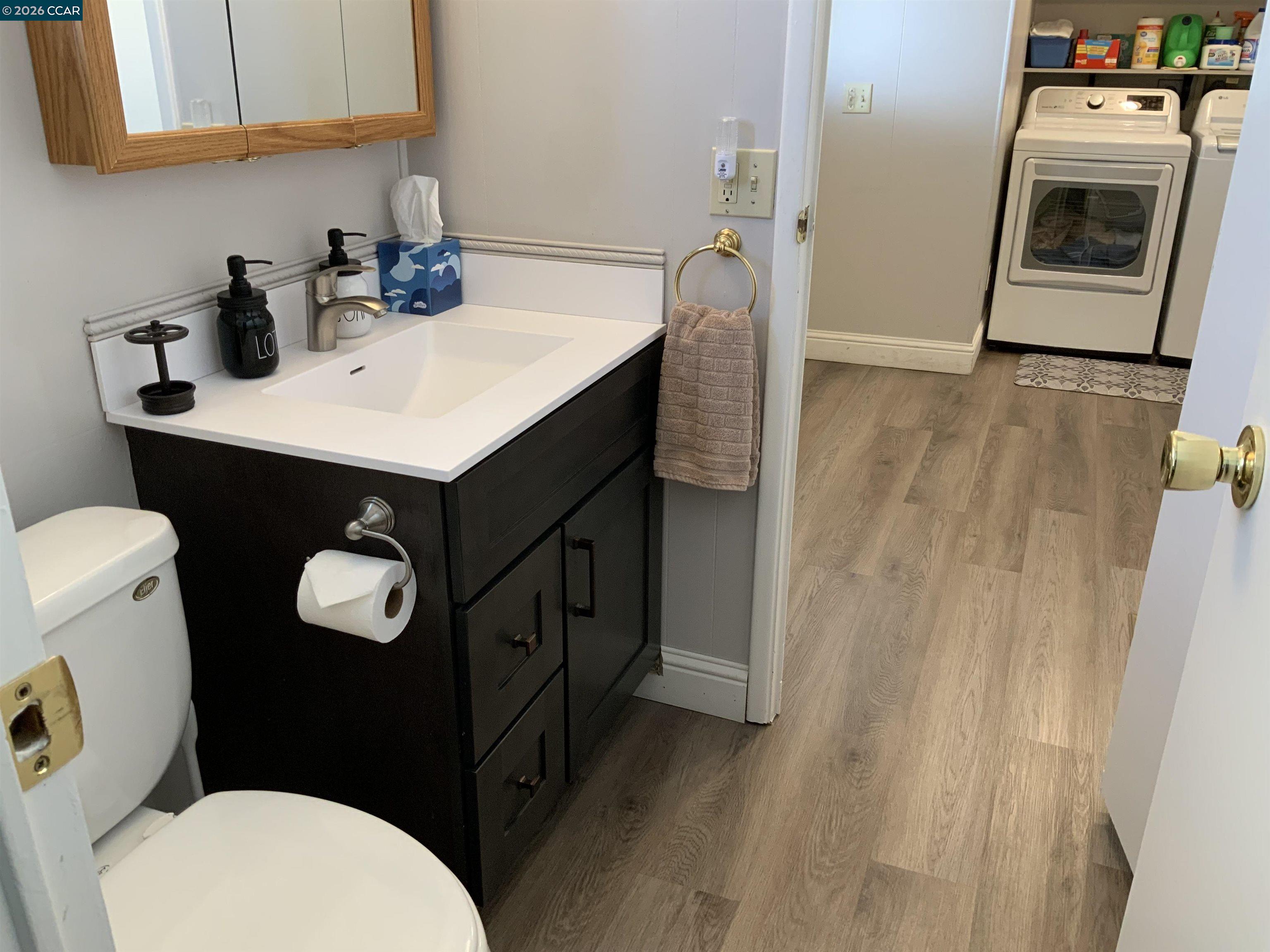 238 Aloha Pittsburg, CA 94565 - Photo 25 of 42 a bathroom with a sink a toilet a mirror and vanity