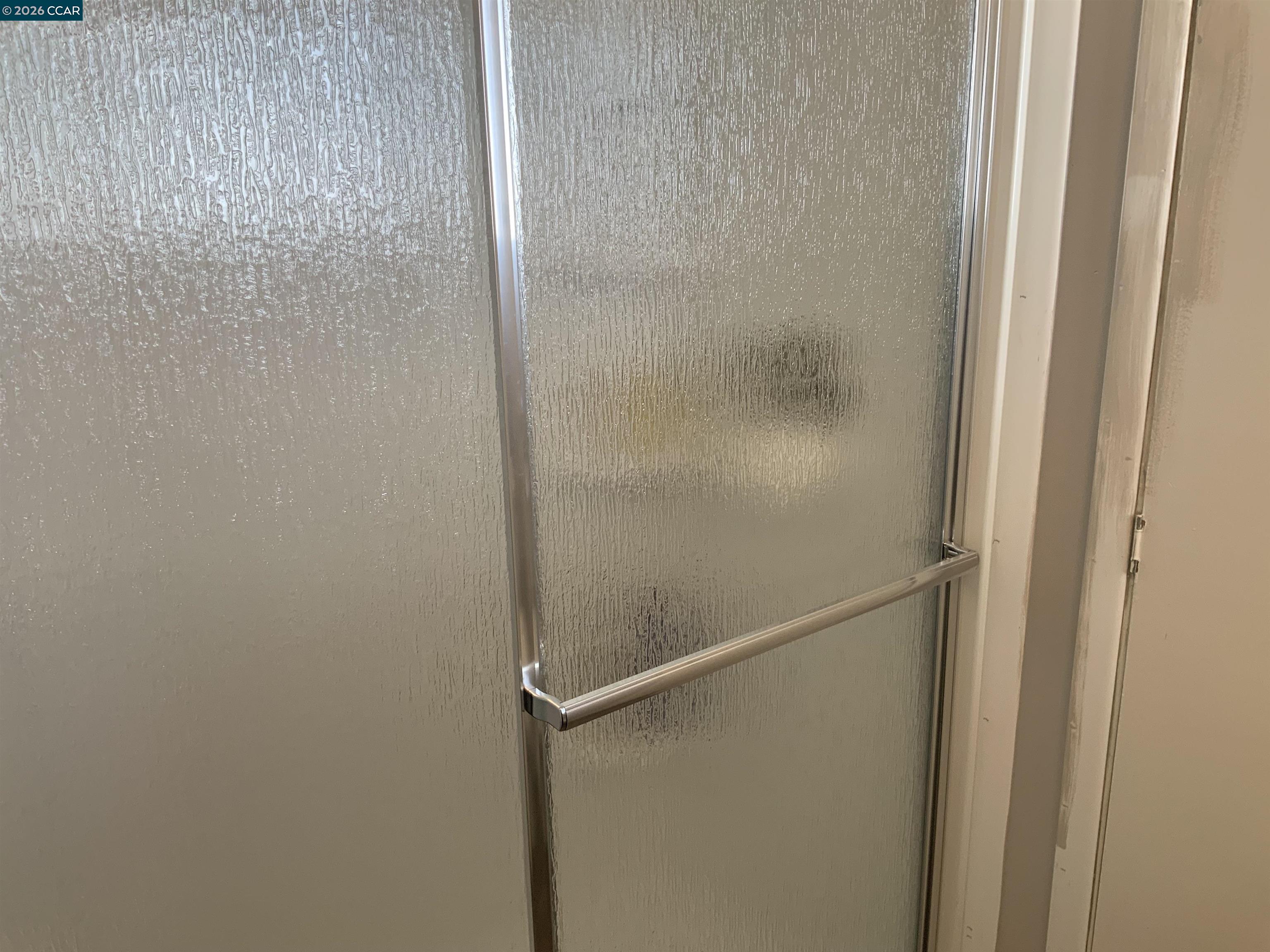 238 Aloha Pittsburg, CA 94565 - Photo 37 of 42 a bathroom with a glass shower door