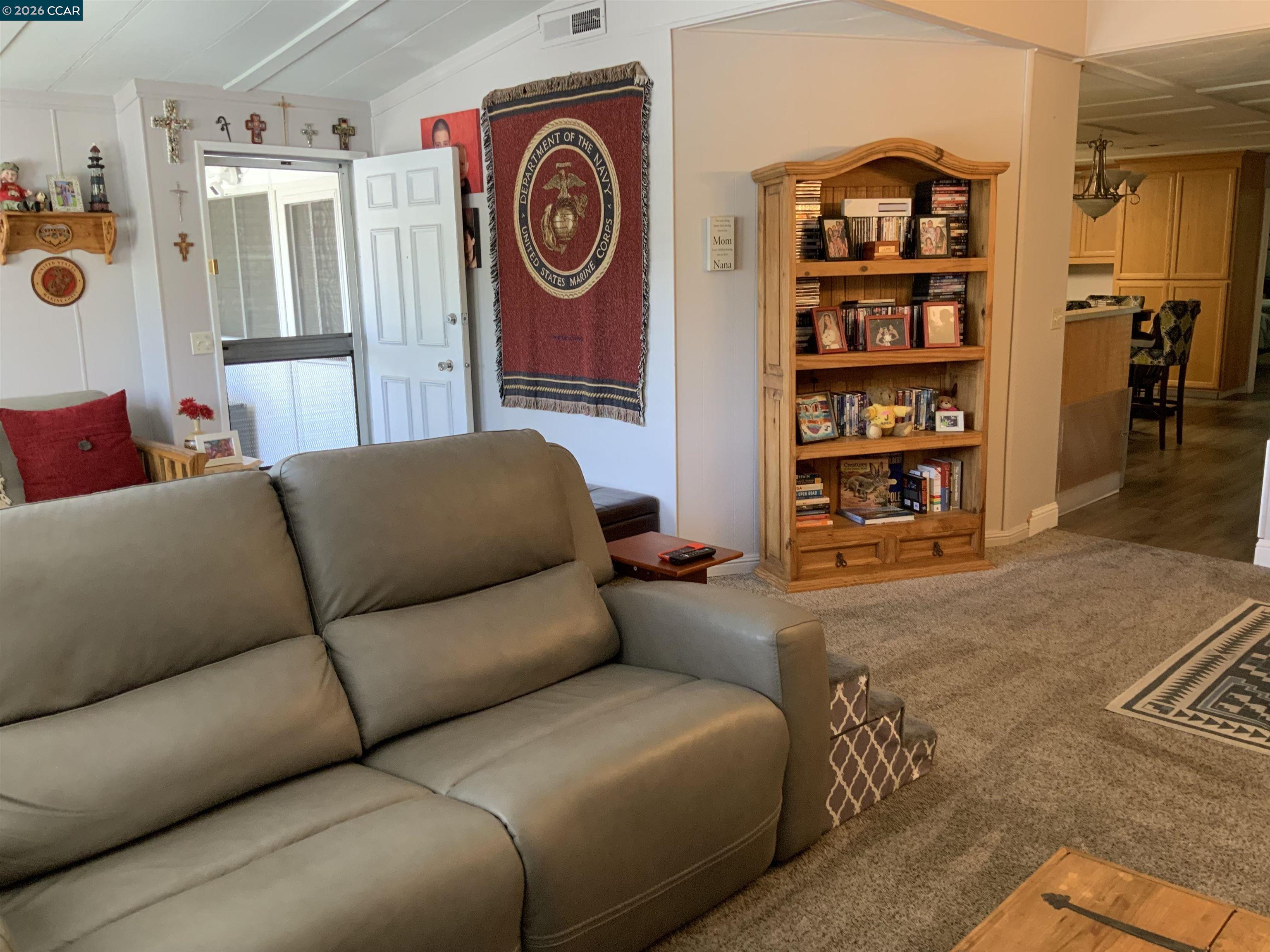 238 Aloha Pittsburg, CA 94565 - Photo 8 of 42 a living room with furniture and a book shelf