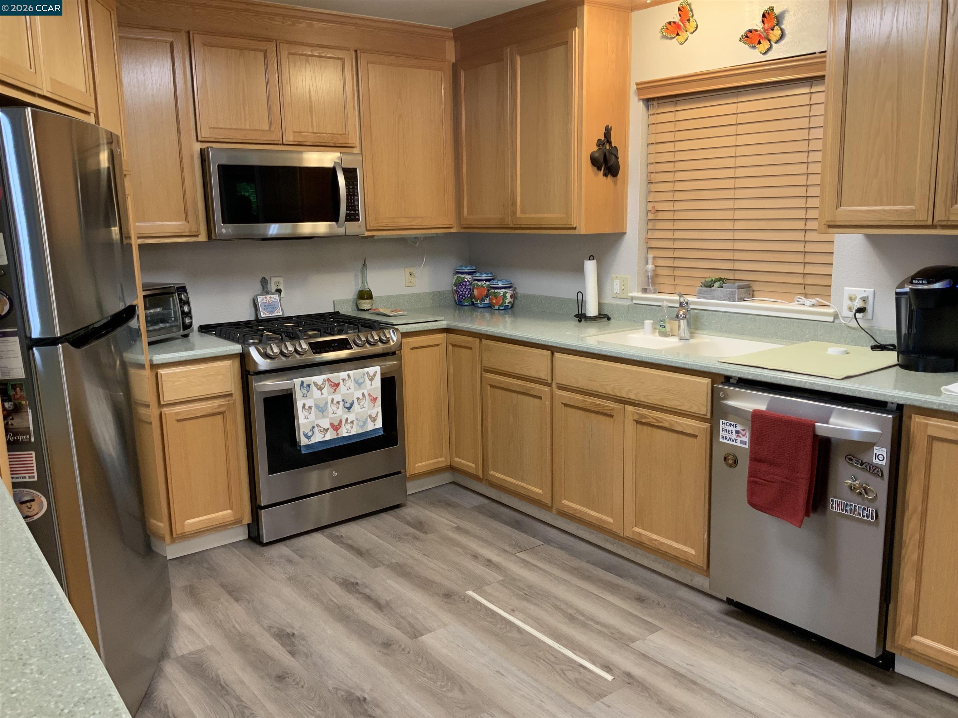 238 Aloha Pittsburg, CA 94565 - Photo 9 of 42 a kitchen with stainless steel appliances granite countertop a stove a sink dishwasher a refrigerator and a microwave