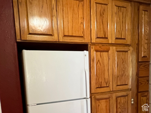 108 South Road Montpelier, ID 83254 - Photo 12 of 36 Kitchen with brown cabinets, freestanding refrigerator, and light wood-style flooring