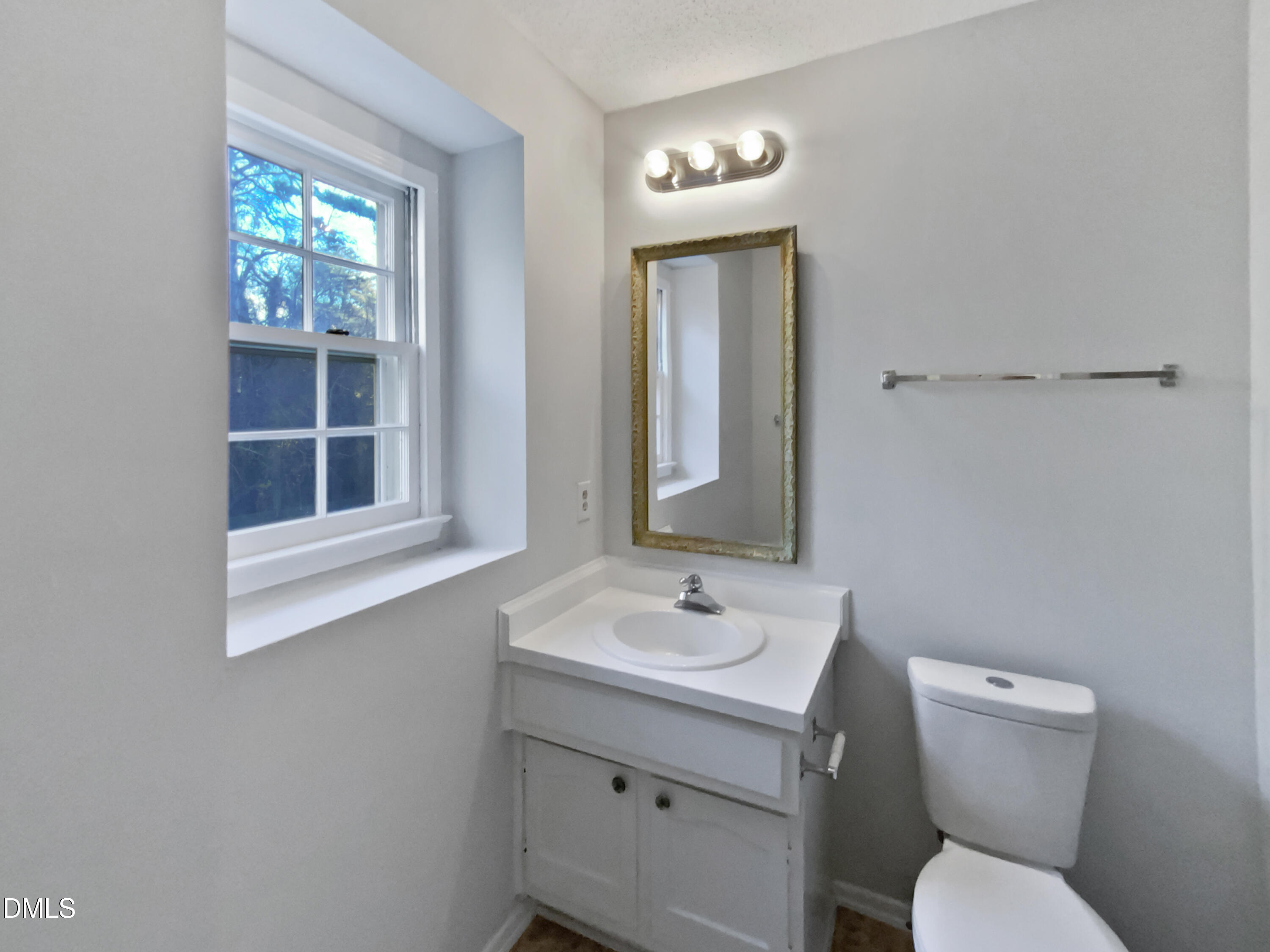 3136 Merrianne Drive Raleigh, NC 27607 - Photo 12 of 20 a bathroom with a toilet sink and mirror