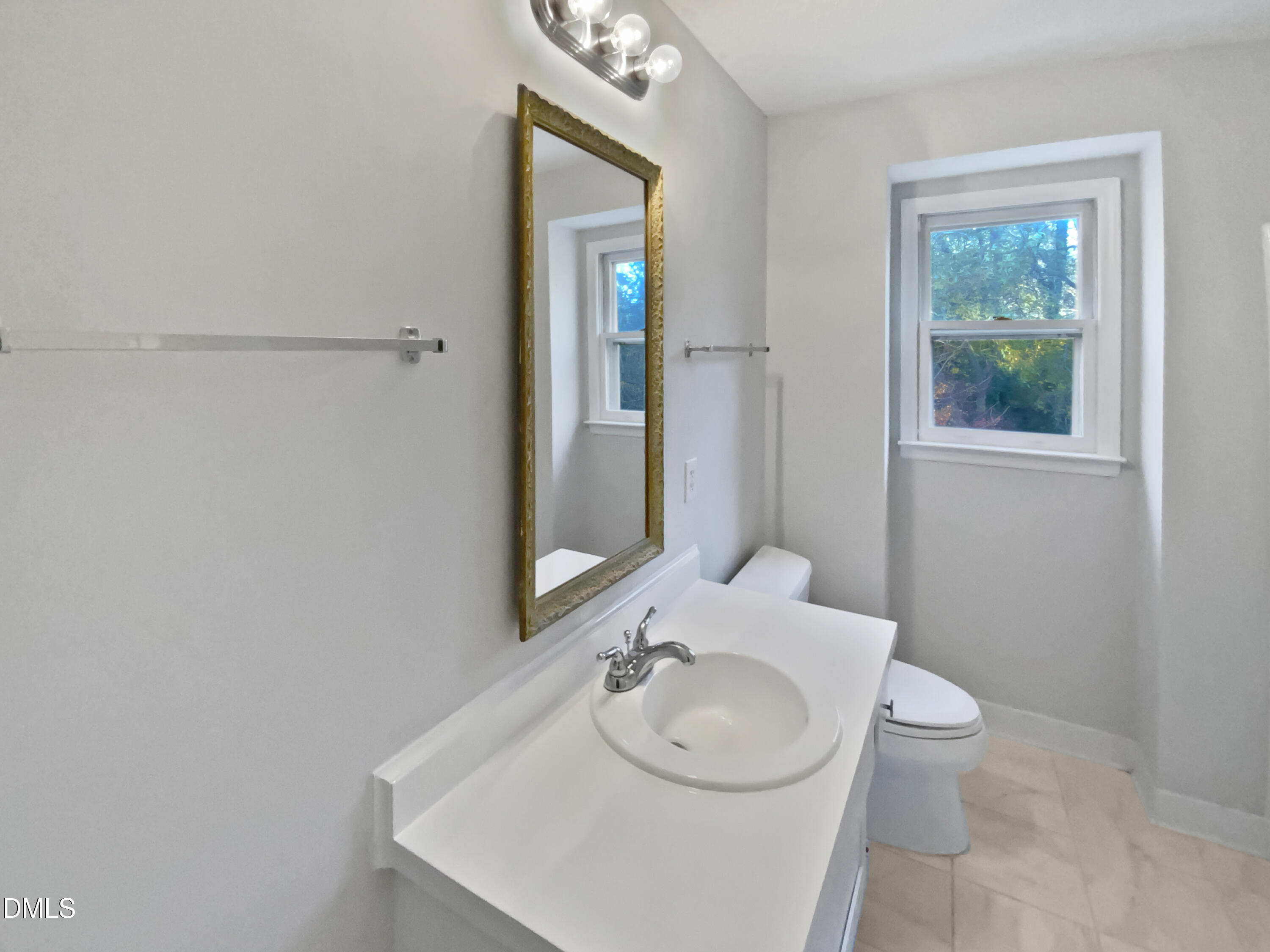 3136 Merrianne Drive Raleigh, NC 27607 - Photo 14 of 20 a bathroom with a sink and a mirror