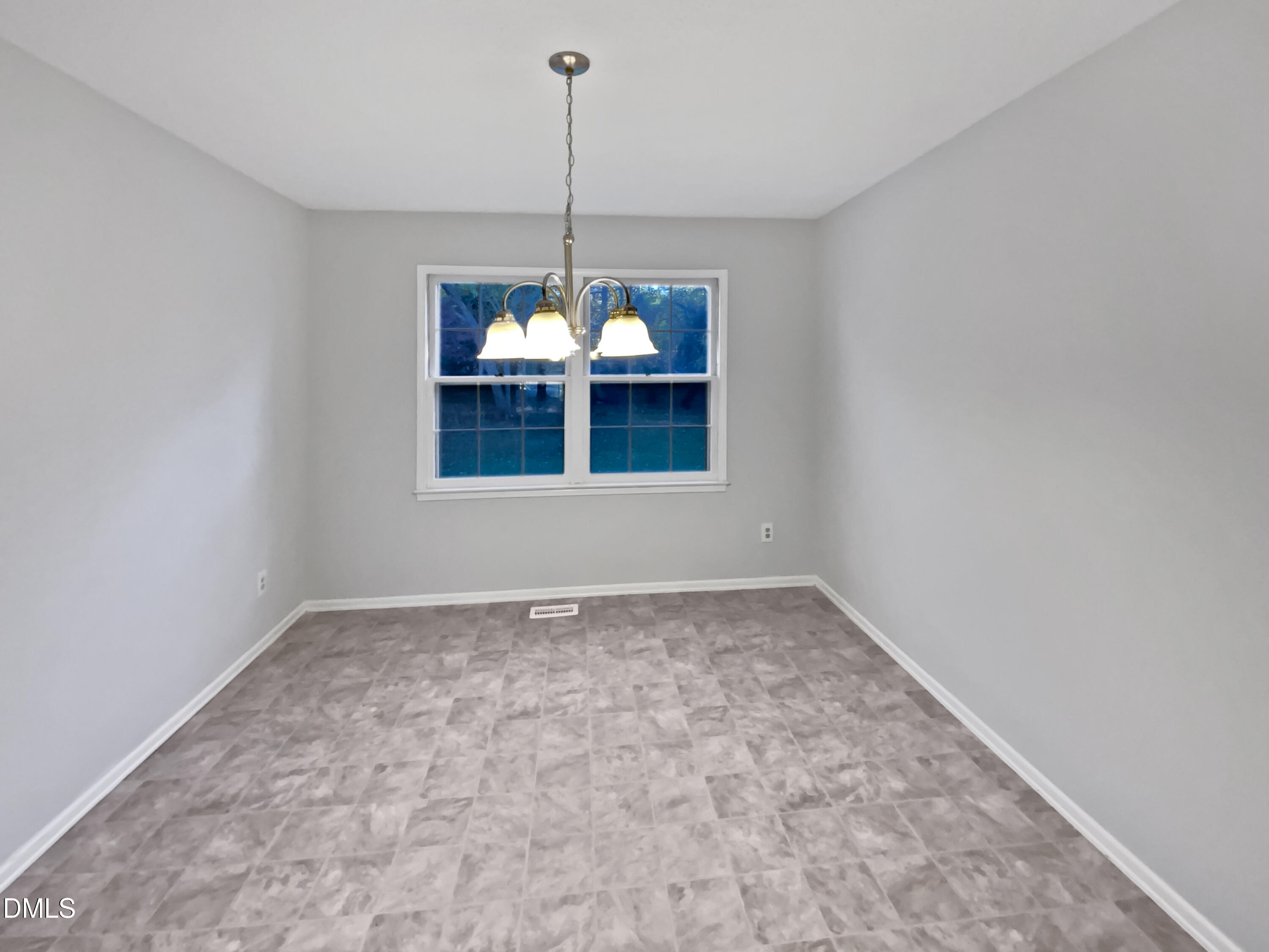 3136 Merrianne Drive Raleigh, NC 27607 - Photo 4 of 20 a view of an empty room with a window