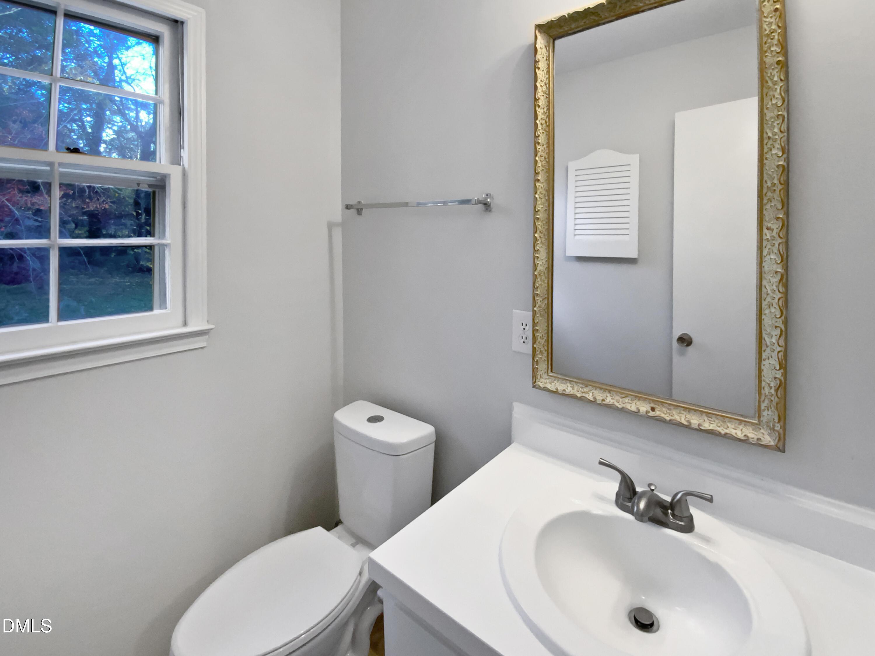 3136 Merrianne Drive Raleigh, NC 27607 - Photo 6 of 20 a bathroom with a sink a toilet and a mirror