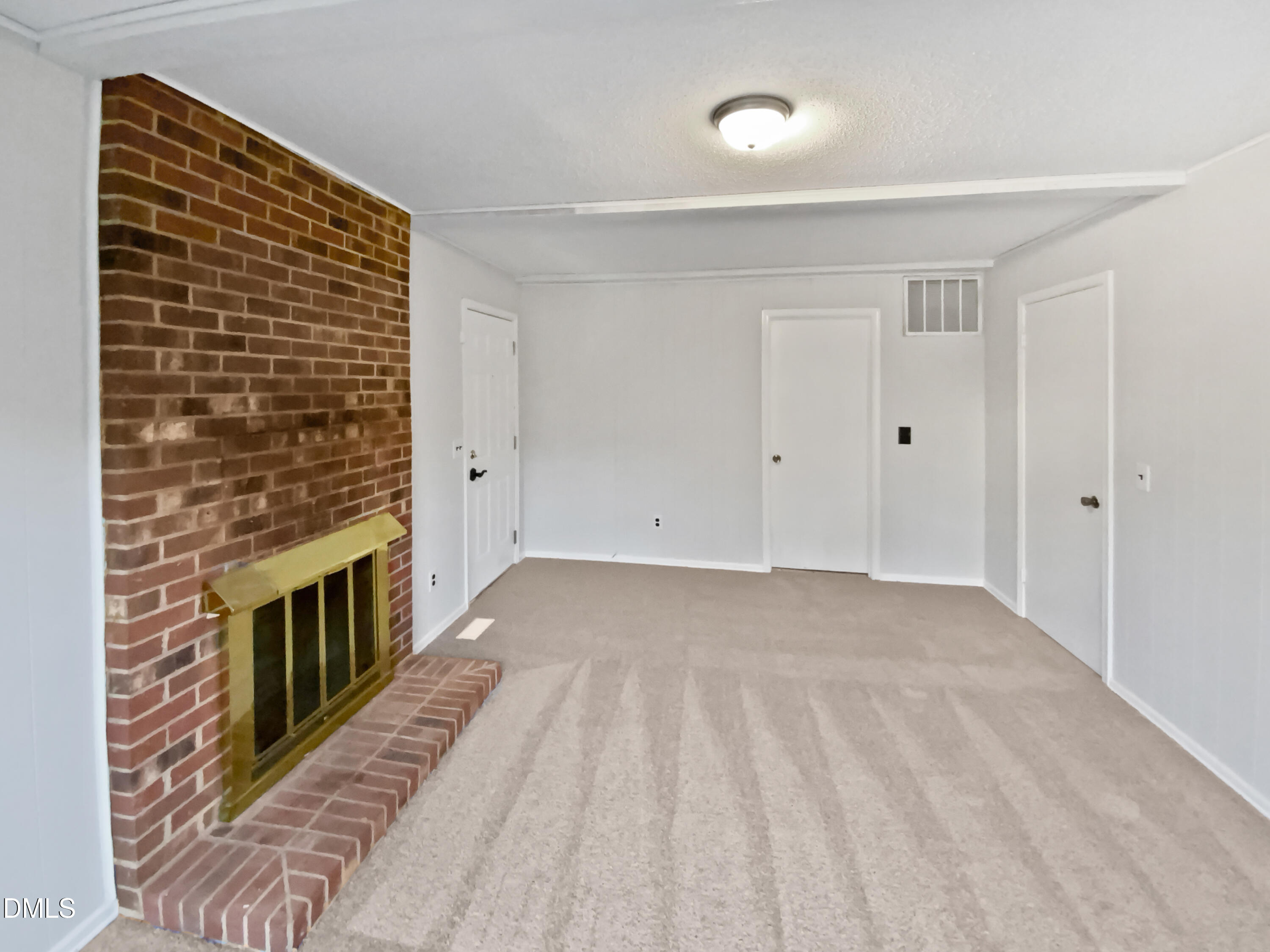 3136 Merrianne Drive Raleigh, NC 27607 - Photo 8 of 20 a view of an empty room with wooden floor and a fireplace